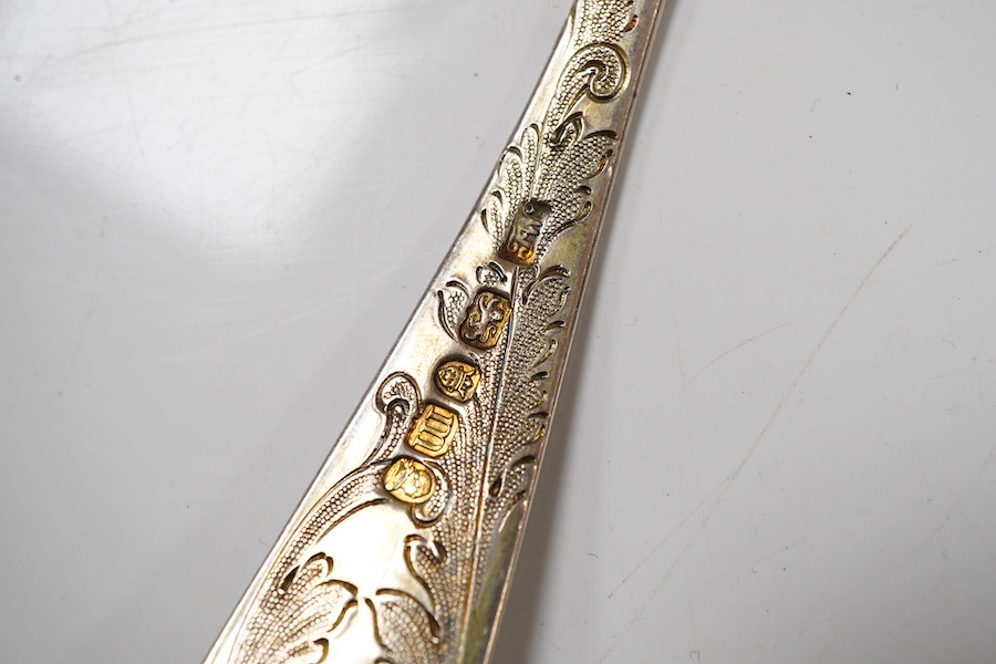 A pair of George III silver gilt Old English pattern berry spoons, London, 1787, 21.8cm, two other earlier silver berry spoons and an Edwardian serving spoon by William Hutton & Sons, London, 1901, 9oz.